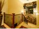 Staircase with carpeted steps, decorative iron railing, and accent wall with stone detail and window at 12797 S 179Th Dr, Goodyear, AZ 85338