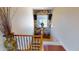 Staircase landing with stone accent wall and window looking out into neighborhood at 12797 S 179Th Dr, Goodyear, AZ 85338