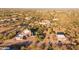 Aerial view of a luxurious estate with pool, guesthouse & horse stables at 14021 E Milton Ct, Scottsdale, AZ 85262