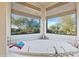 Oval bathtub with corner windows offering scenic views at 14021 E Milton Ct, Scottsdale, AZ 85262