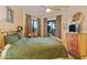 Bedroom with wooden bed frame and access to patio at 14021 E Milton Ct, Scottsdale, AZ 85262
