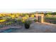 Deck overlooking desert landscape, pool, and mountains in the distance at 14021 E Milton Ct, Scottsdale, AZ 85262