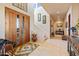 Spacious entryway with high ceilings, decorative rug, and wooden doors at 14021 E Milton Ct, Scottsdale, AZ 85262