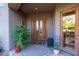 Home's entrance with double doors and well-placed plants at 14021 E Milton Ct, Scottsdale, AZ 85262