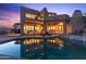 Luxury home with a stunning pool and desert landscape at sunset at 14021 E Milton Ct, Scottsdale, AZ 85262