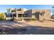 Luxury home with stucco exterior, multiple windows, and a landscaped front yard at 14021 E Milton Ct, Scottsdale, AZ 85262