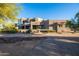 Luxury home with stucco exterior, multiple windows, and a landscaped front yard at 14021 E Milton Ct, Scottsdale, AZ 85262