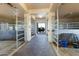 Spacious horse stable interior with multiple stalls and a brick pathway at 14021 E Milton Ct, Scottsdale, AZ 85262