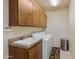 Laundry room with washer, dryer, and upper cabinets at 14021 E Milton Ct, Scottsdale, AZ 85262