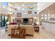 Open living room with a stone fireplace, high ceilings, and access to a back patio at 14021 E Milton Ct, Scottsdale, AZ 85262
