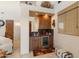 Convenient wet bar with wood cabinetry, granite countertop and a wine cooler at 14021 E Milton Ct, Scottsdale, AZ 85262