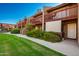 Condo building exterior showcasing multiple units and a well-maintained lawn at 14203 N 19Th Ave # 1055, Phoenix, AZ 85023