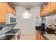 Bright kitchen with granite counters, wood cabinets, and a view to living area at 14203 N 19Th Ave # 1055, Phoenix, AZ 85023
