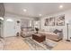 Bright living room with a sofa, ottoman, and large mirror at 14203 N 19Th Ave # 1055, Phoenix, AZ 85023
