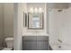 Bathroom with grey cabinets, mosaic backsplash and shower-tub combo at 578 E Las Puertas Ln, Queen Creek, AZ 85140