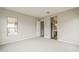 Large bedroom with neutral carpet and walls plus views into the bathroom at 578 E Las Puertas Ln, Queen Creek, AZ 85140