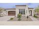 Charming single-story home with a desert-landscaped front yard and a stylish brown garage door at 578 E Las Puertas Ln, Queen Creek, AZ 85140
