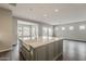Bright, open-concept kitchen featuring a large island with a farmhouse sink and stainless steel appliances at 578 E Las Puertas Ln, Queen Creek, AZ 85140