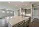 Spacious kitchen with a large island, farmhouse sink, gray cabinets, and stainless steel appliances at 578 E Las Puertas Ln, Queen Creek, AZ 85140