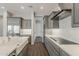 Modern kitchen boasts gray cabinetry, quartz countertops, stainless steel appliances, and wood-look flooring at 578 E Las Puertas Ln, Queen Creek, AZ 85140