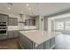 Well-appointed kitchen featuring a large island, modern appliances, and stylish gray cabinetry at 578 E Las Puertas Ln, Queen Creek, AZ 85140