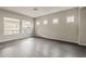 A modern, neutral-toned living room with plenty of natural light from the windows at 578 E Las Puertas Ln, Queen Creek, AZ 85140