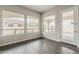 Bright and airy living room space with wood floors and large windows with views to the backyard at 578 E Las Puertas Ln, Queen Creek, AZ 85140