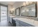 Main bathroom with double vanity sinks, white countertops, and a view of the shower at 578 E Las Puertas Ln, Queen Creek, AZ 85140