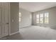 Spacious main bedroom with three windows and neutral carpet flooring at 578 E Las Puertas Ln, Queen Creek, AZ 85140