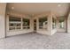 Covered patio with stone pavers, windows throughout and neutral paint at 578 E Las Puertas Ln, Queen Creek, AZ 85140