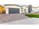 Home featuring paved driveway, garage, and partial view of front exterior at 7583 W Gelding Dr, Peoria, AZ 85381