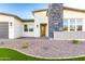 Stunning home featuring stone accents, a well-manicured yard, and a welcoming entrance at 7583 W Gelding Dr, Peoria, AZ 85381