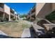 A serene courtyard featuring green grass, decorative rocks, and a stone bench for relaxing outdoors at 2228 N 52Nd St # 227, Phoenix, AZ 85008