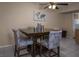 The dining area includes a wood table with four upholstered chairs and a decorative ceiling fan at 2228 N 52Nd St # 227, Phoenix, AZ 85008