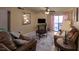The living room has leather sofas, a ceiling fan, and access to the balcony at 2228 N 52Nd St # 227, Phoenix, AZ 85008
