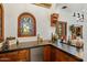 Stylish bar area features custom wood cabinetry, counter space, and a stained-glass window at 7533 N 70Th St, Paradise Valley, AZ 85253