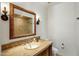 Elegant bathroom with a marble countertop, decorative mirror, and ornate sconces at 7533 N 70Th St, Paradise Valley, AZ 85253