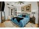 Comfortable bedroom with a blue quilted bedspread, decorative pillows and stylish floral artwork at 7533 N 70Th St, Paradise Valley, AZ 85253
