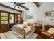 Comfortable bedroom with wood-beamed ceiling, ceiling fan, and access to an outdoor patio with stunning arched door at 7533 N 70Th St, Paradise Valley, AZ 85253