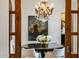 Formal dining room with crystal chandelier and sliding barn doors providing an elegant ambiance at 7533 N 70Th St, Paradise Valley, AZ 85253