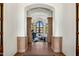 Arched foyer entrance showcases a piano room with high ceilings, stone columns and tile flooring at 7533 N 70Th St, Paradise Valley, AZ 85253
