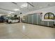 Spacious garage with epoxy flooring, custom storage cabinets, and a golf cart at 7533 N 70Th St, Paradise Valley, AZ 85253