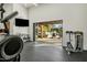 Home gym with exercise equipment and an open doorway to the pool area at 7533 N 70Th St, Paradise Valley, AZ 85253