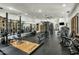Spacious home gym with mirrors, wood floors, drop ceilings, and an array of exercise equipment at 7533 N 70Th St, Paradise Valley, AZ 85253