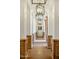 Elegant hallway features decorative columns, tile flooring, and lantern-style chandeliers at 7533 N 70Th St, Paradise Valley, AZ 85253