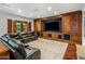 Inviting living room with a large leather sectional, custom wood built-ins, and ample space for entertainment at 7533 N 70Th St, Paradise Valley, AZ 85253