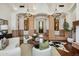 Open living room featuring chandeliers, arched doorways, stone columns, and elegant furnishings at 7533 N 70Th St, Paradise Valley, AZ 85253