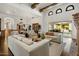 Open concept living area with wood beamed ceilings and view to the outdoor entertainment area at 7533 N 70Th St, Paradise Valley, AZ 85253