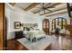 Luxurious main bedroom features wood beam ceiling, arched windows and door, and warm, inviting decor at 7533 N 70Th St, Paradise Valley, AZ 85253