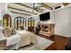 Luxurious main bedroom with a stone fireplace, exposed wood beam ceiling, and beautiful hardwood floors at 7533 N 70Th St, Paradise Valley, AZ 85253